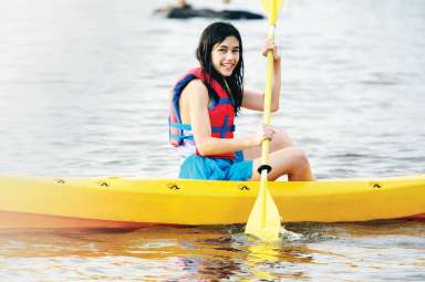 Girl in kayak on lake