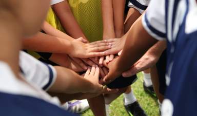 group of young people’s hands